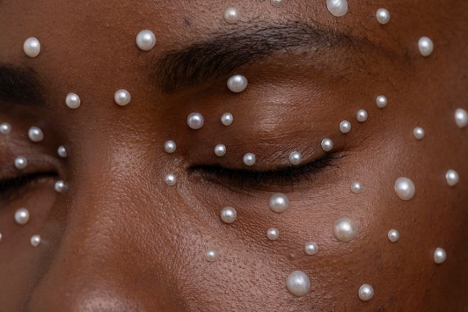 Close-up of woman wearing pearl freckles