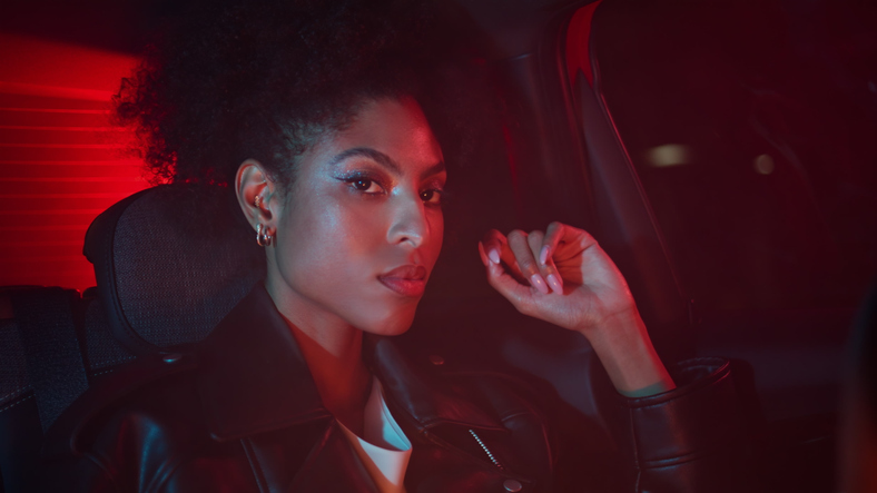 Taxi passenger sitting backseat automobile closeup. African woman night trip