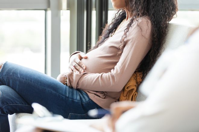 Pregnant Woman in Therapy Session, Mental Health Care
