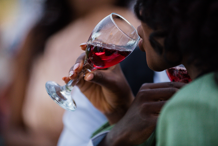 Close-up of a woman enjoying a glass of red wine