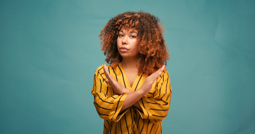 Young Hispanic Woman Shows Stop No Gesture on Blue Background