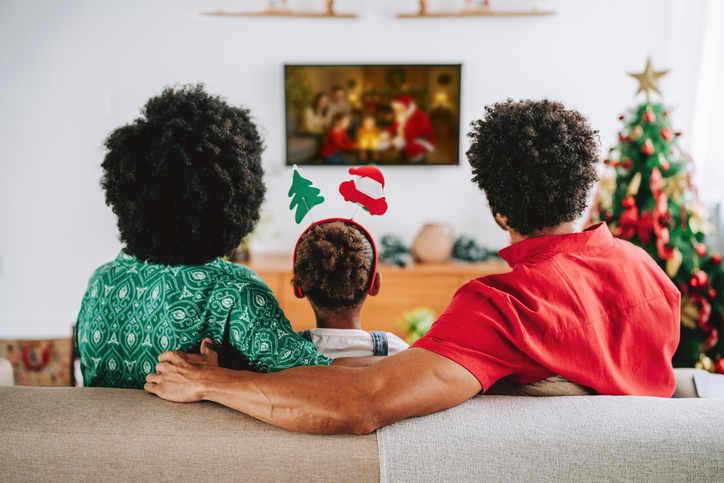 Family Watching Christmas Movie Together at Home