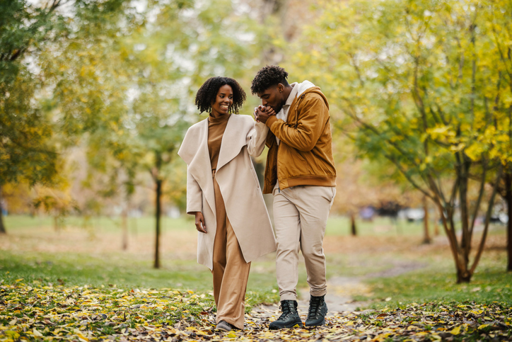 Young black couple enjoying romantic autumn park walk